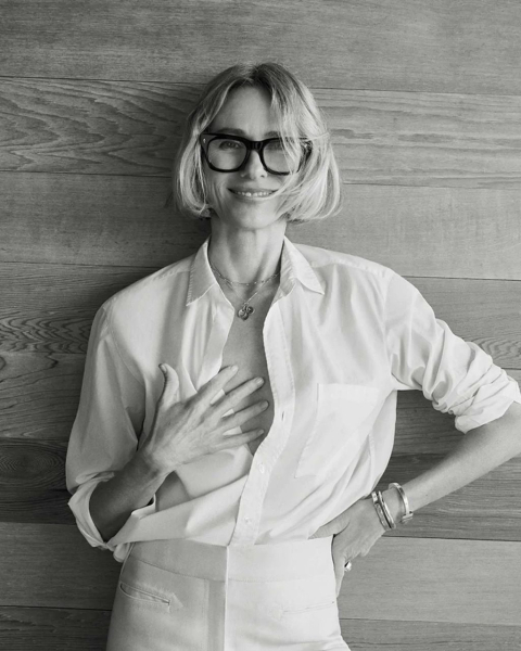 black and white photo of Naomi Watts in front of a wood background