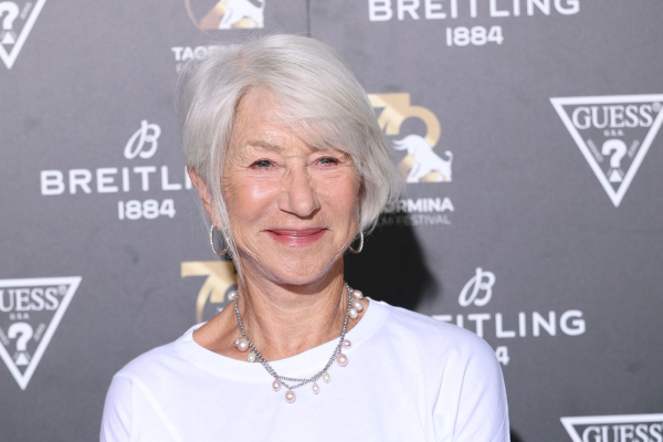 Helen Mirren wears a white top pearl necklace and has her hair styled in an asymmetrical bixie.